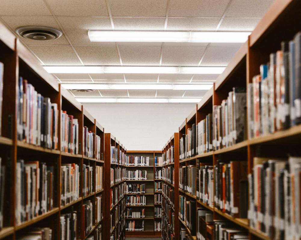 An empty library aisle lined with bookshelves
