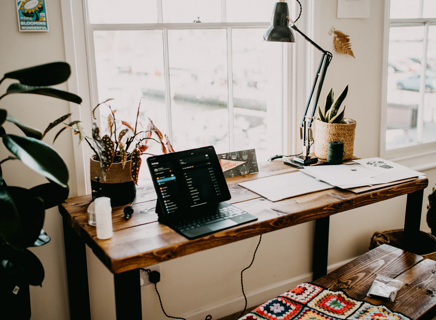 An empty workspace with a laptop beside a window