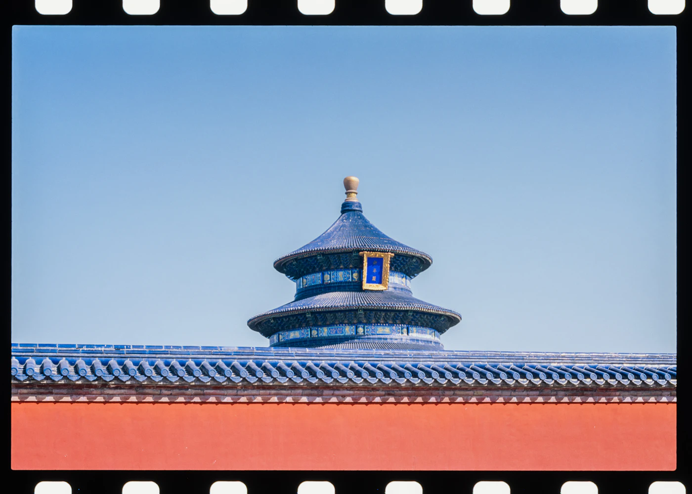 Temple of Heaven roof and red wall beneath a blue sky in Beijing