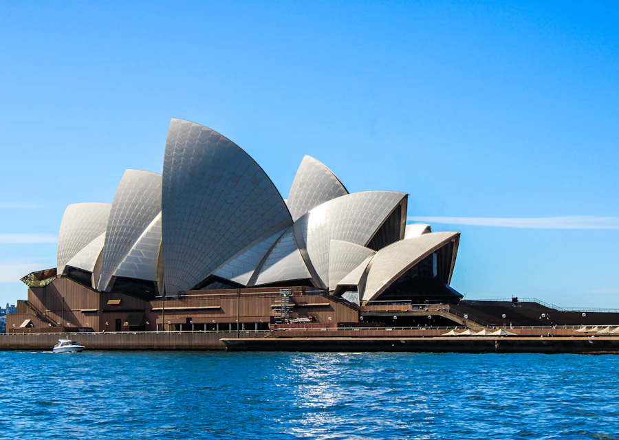 Sydney Opera House beside the blue waters of Sydney Harbour